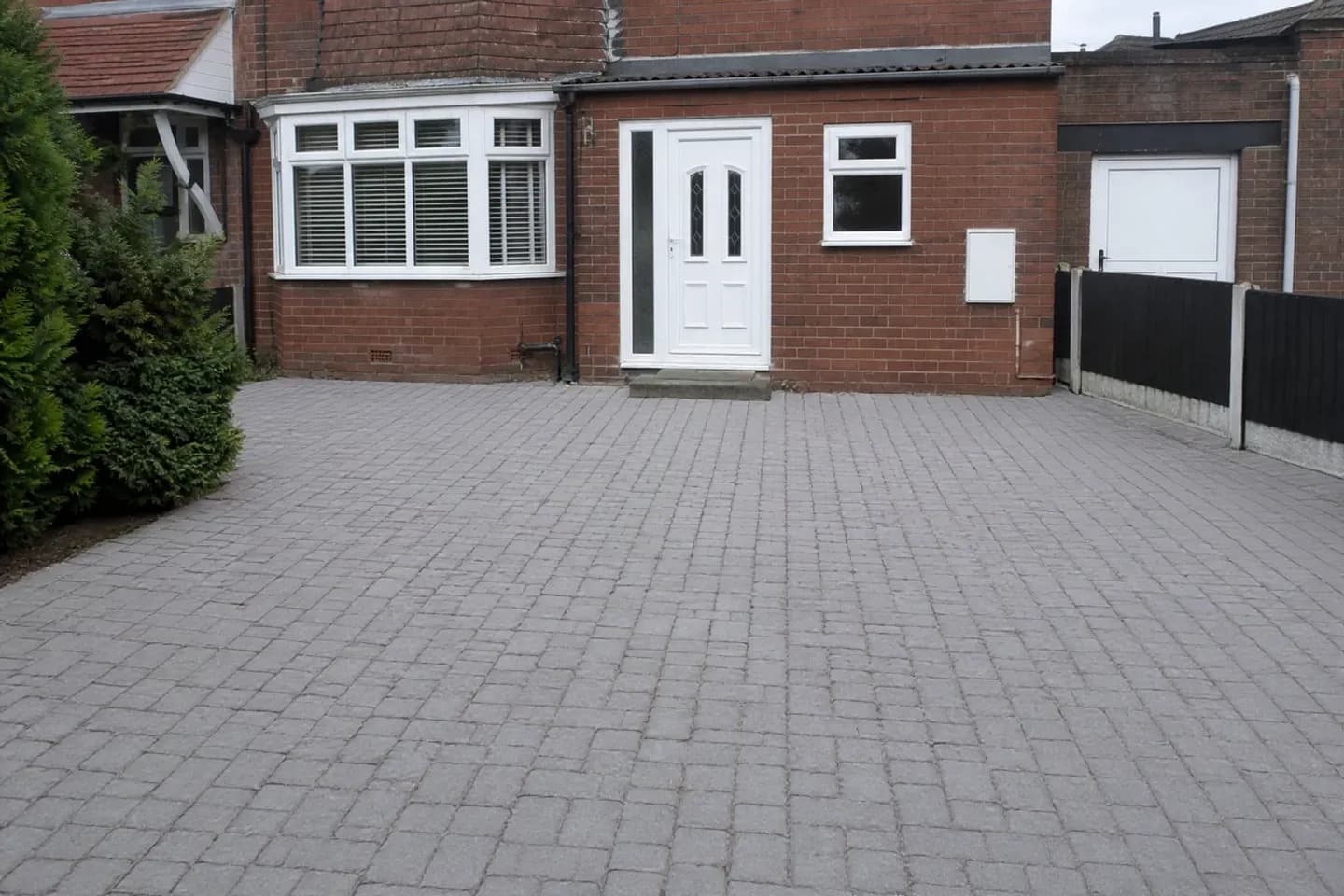 The same block-paved driveway clean and uniform with crisp re-sanded joints after professional cleaning