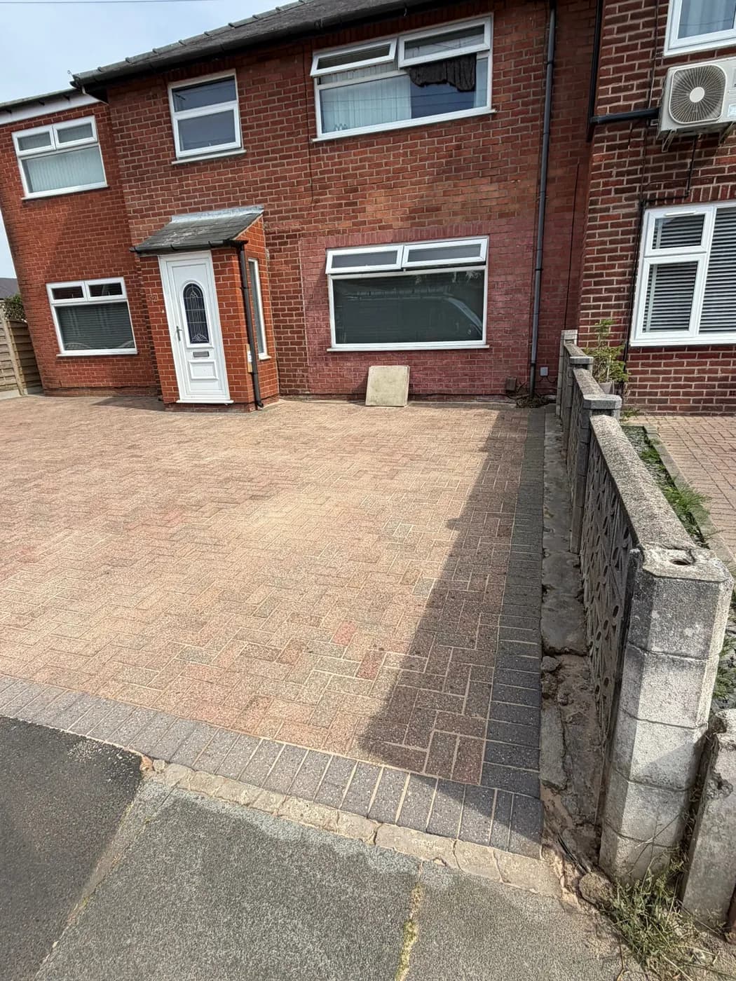 Cleaned block paving with a crisp charcoal border course