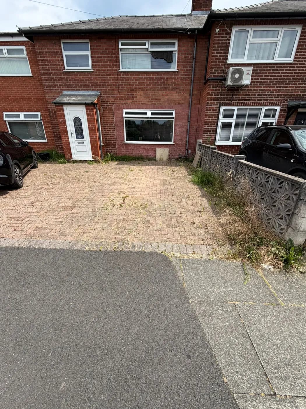 Weedy block paving with jointing sand washed out before restoration