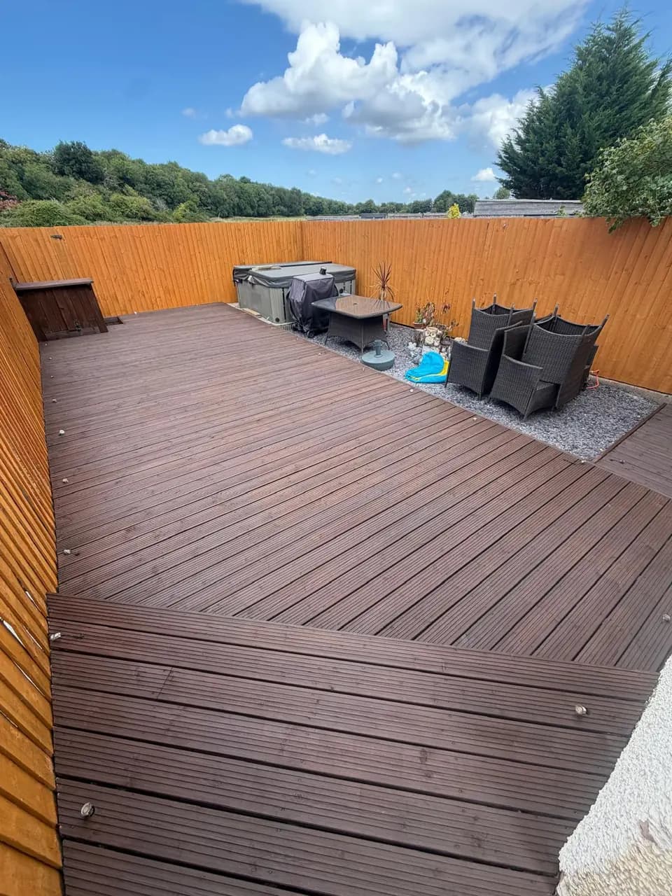 Completed garden with dark restored decking and warm treated fencing