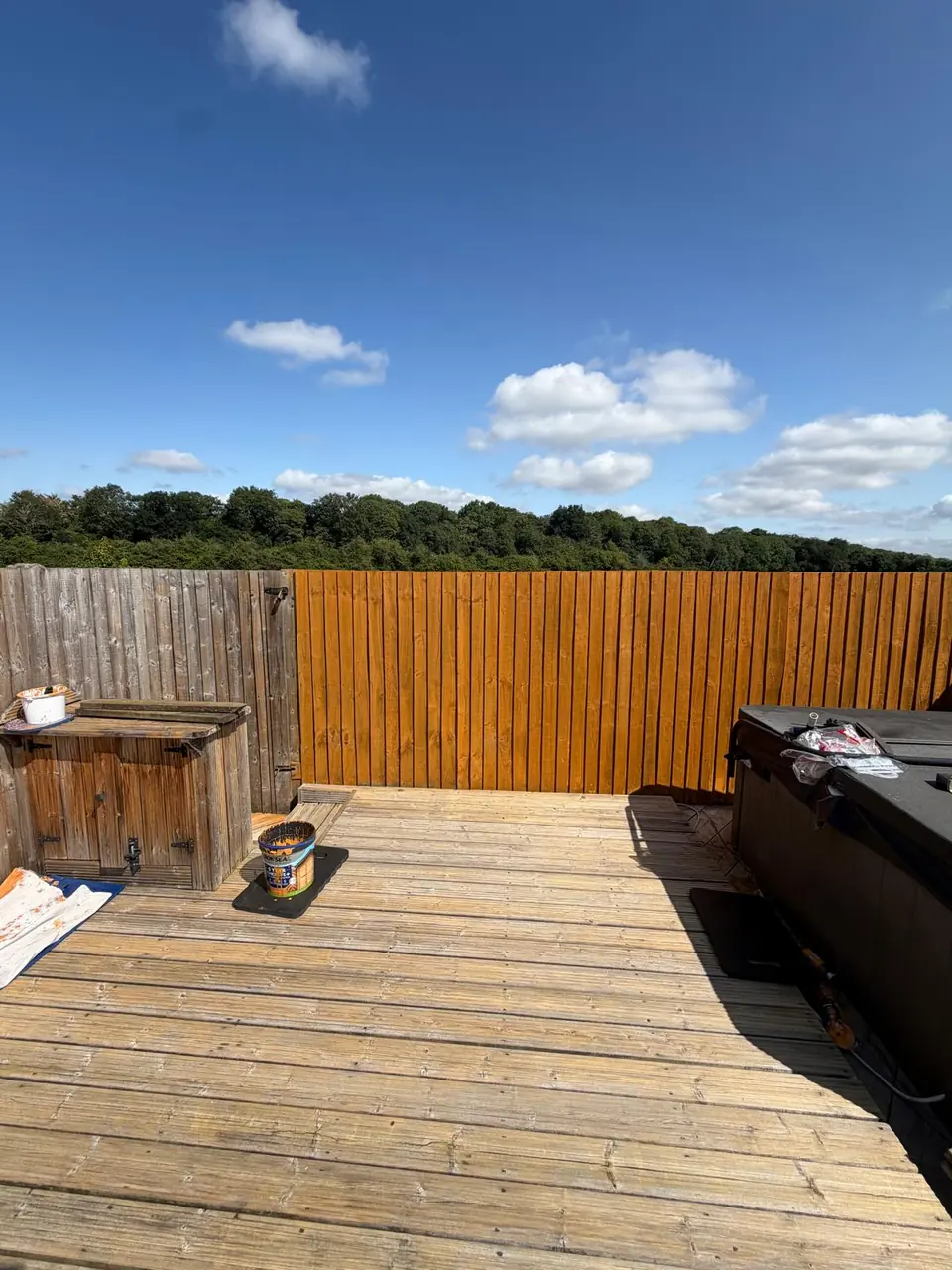 First run of garden fence panels treated in a warm timber tone during the project