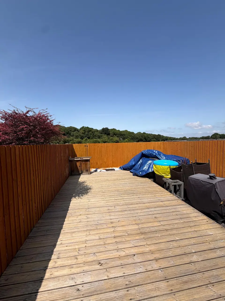 Wide view of treated garden fencing while the decking awaits its final finish