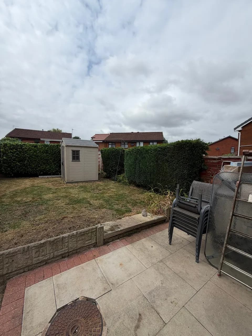 Tidy Warrington garden viewed from the patio after hedge trimming and grass cutting