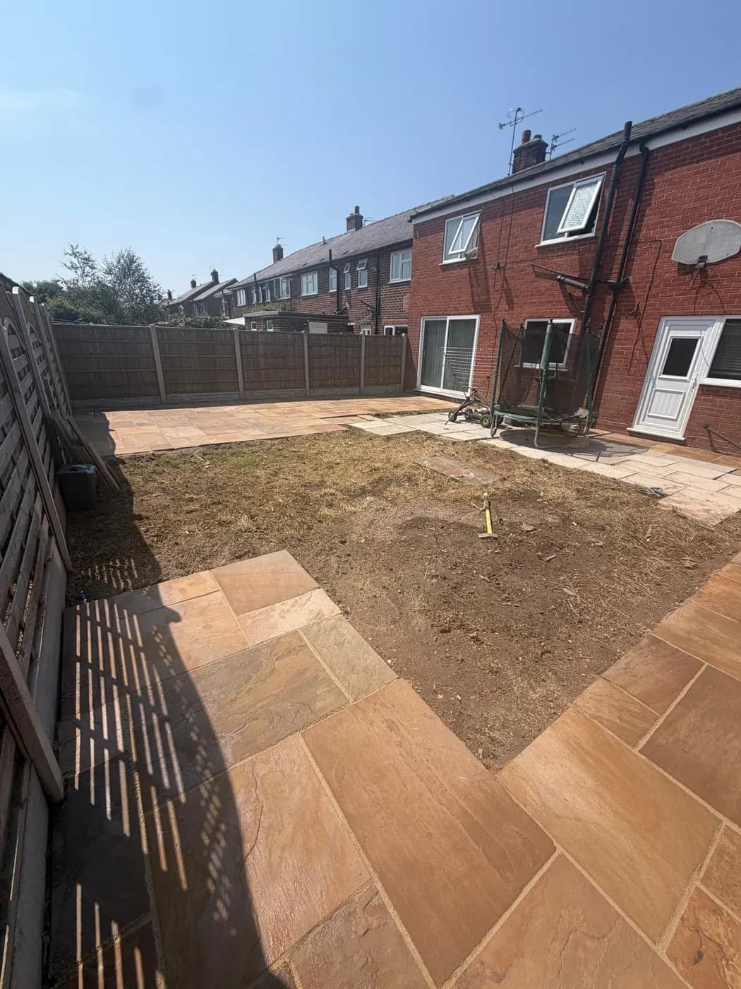 The Warrington garden fully cleared with the sandstone patio restored around the edges