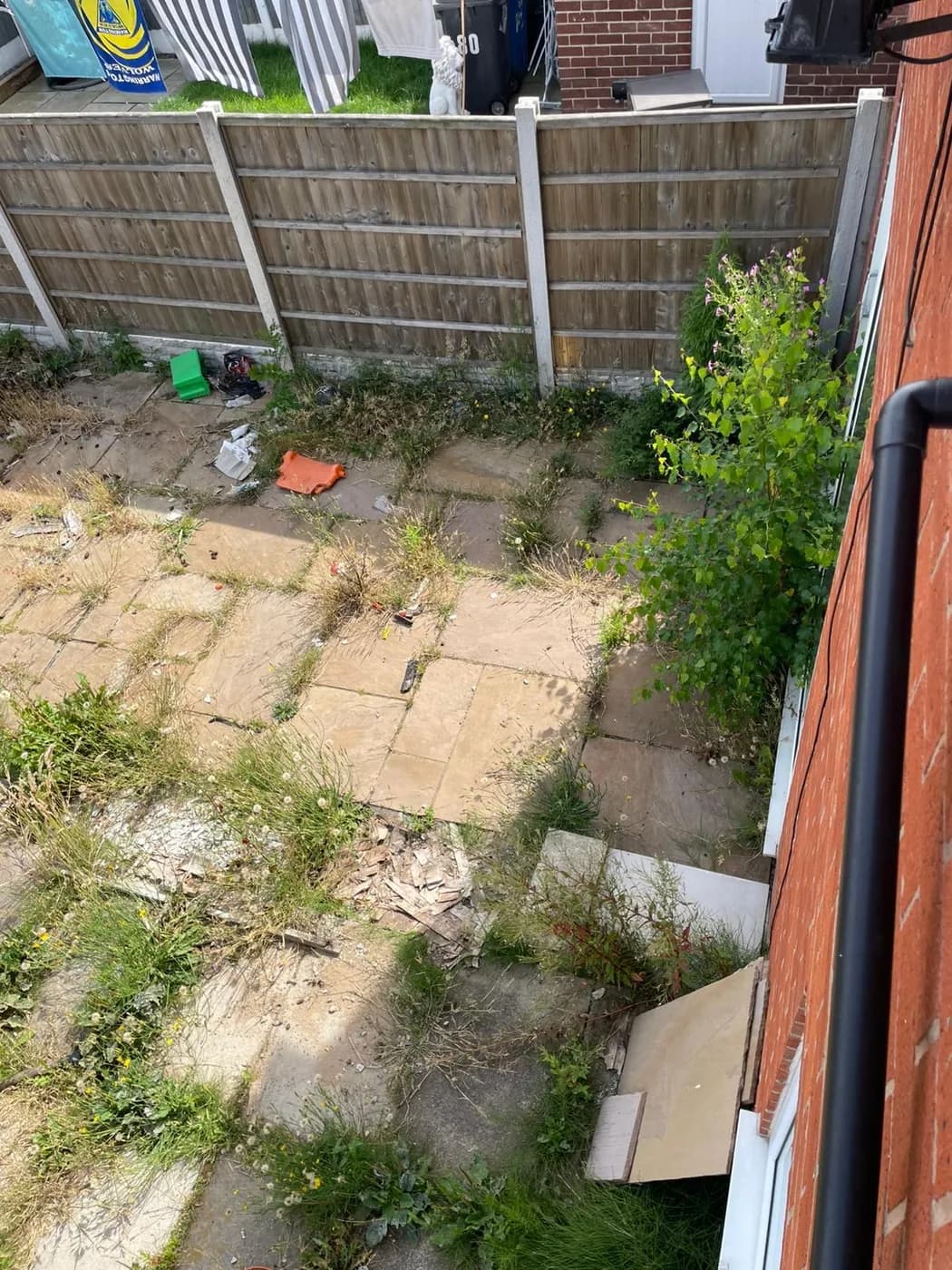 Rubble, broken slabs and debris on the patio before removal