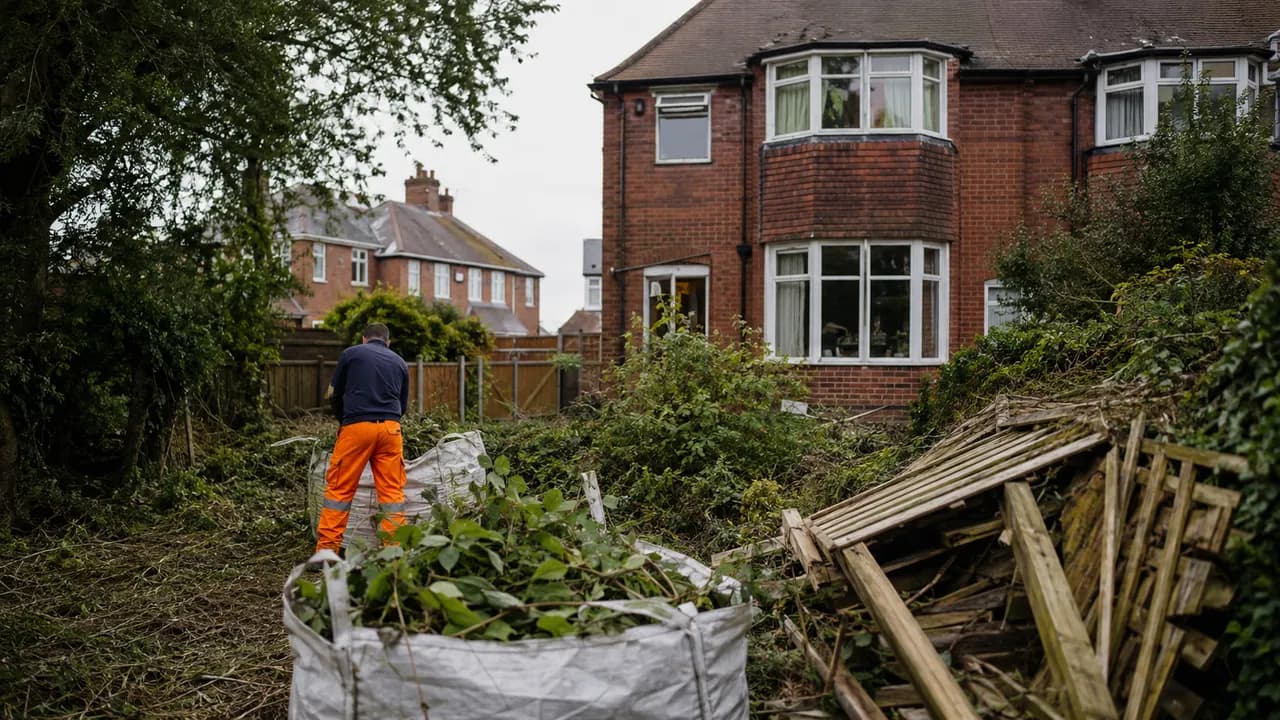 Garden clearance in progress on a 1930s red-brick semi-detached house with a bay window on a tree-lined Wirral suburban street