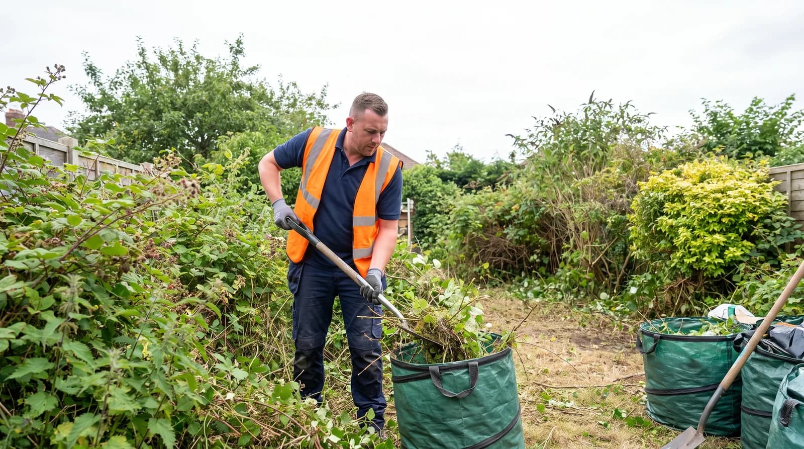 CPAGM tradesman clearing an overgrown garden into green waste bags in Chester