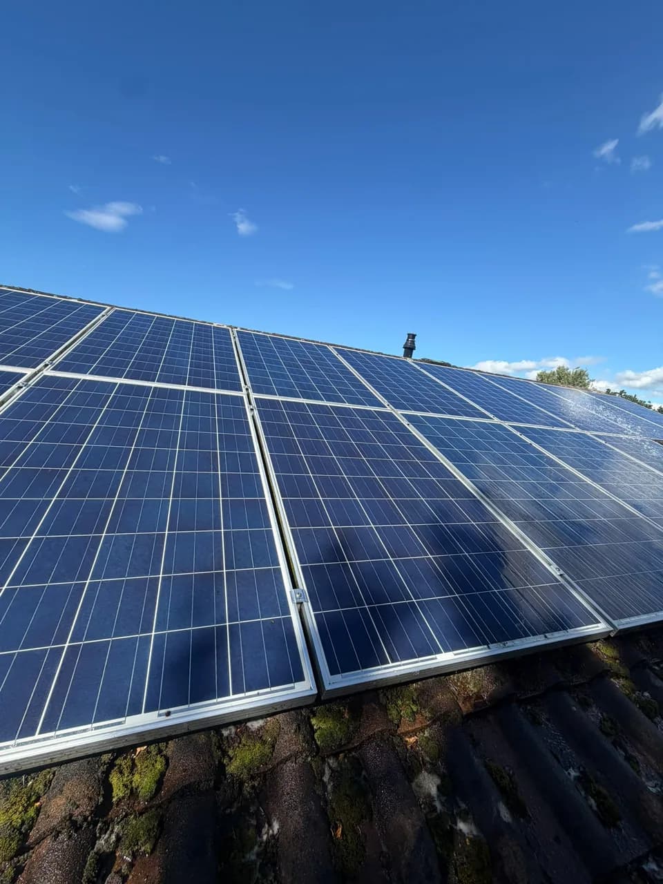 Wide finished view of the same roof-mounted solar array after cleaning
