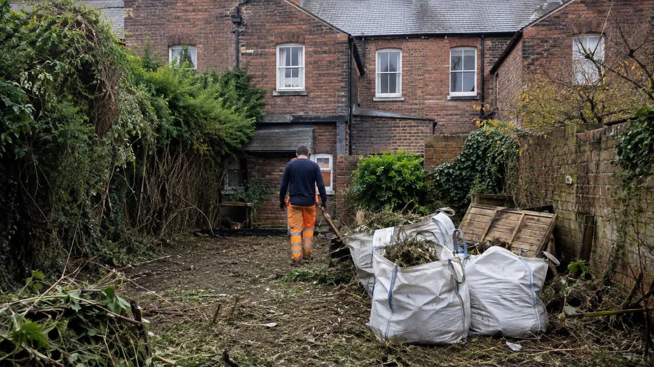 Garden clearance in progress on a Victorian brick terraced house near the centre of Chester with a slate roof and sash windows